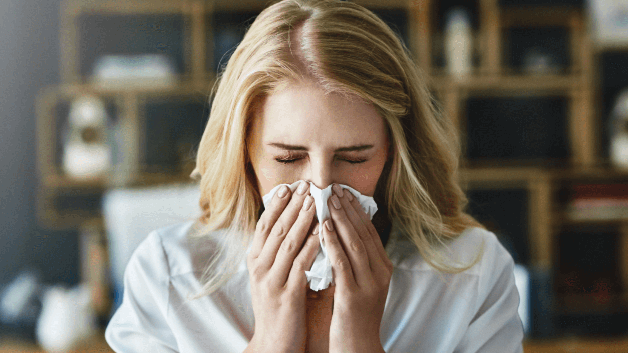 woman blowing her nose